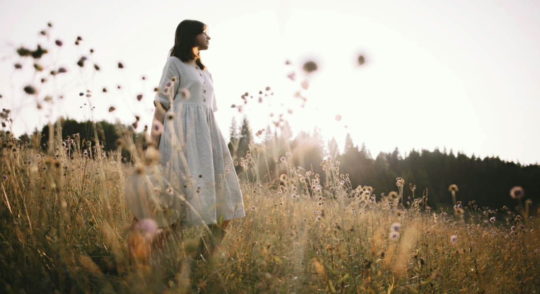 woman walking through wheat field